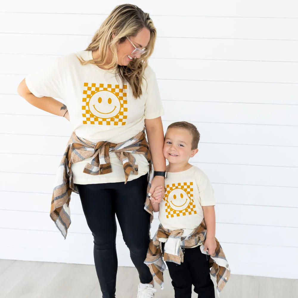 Trendy Sweet Wink Hazel Smiley Checker Short Sleeve Toddler Unisex T-Shirt in Natural Color